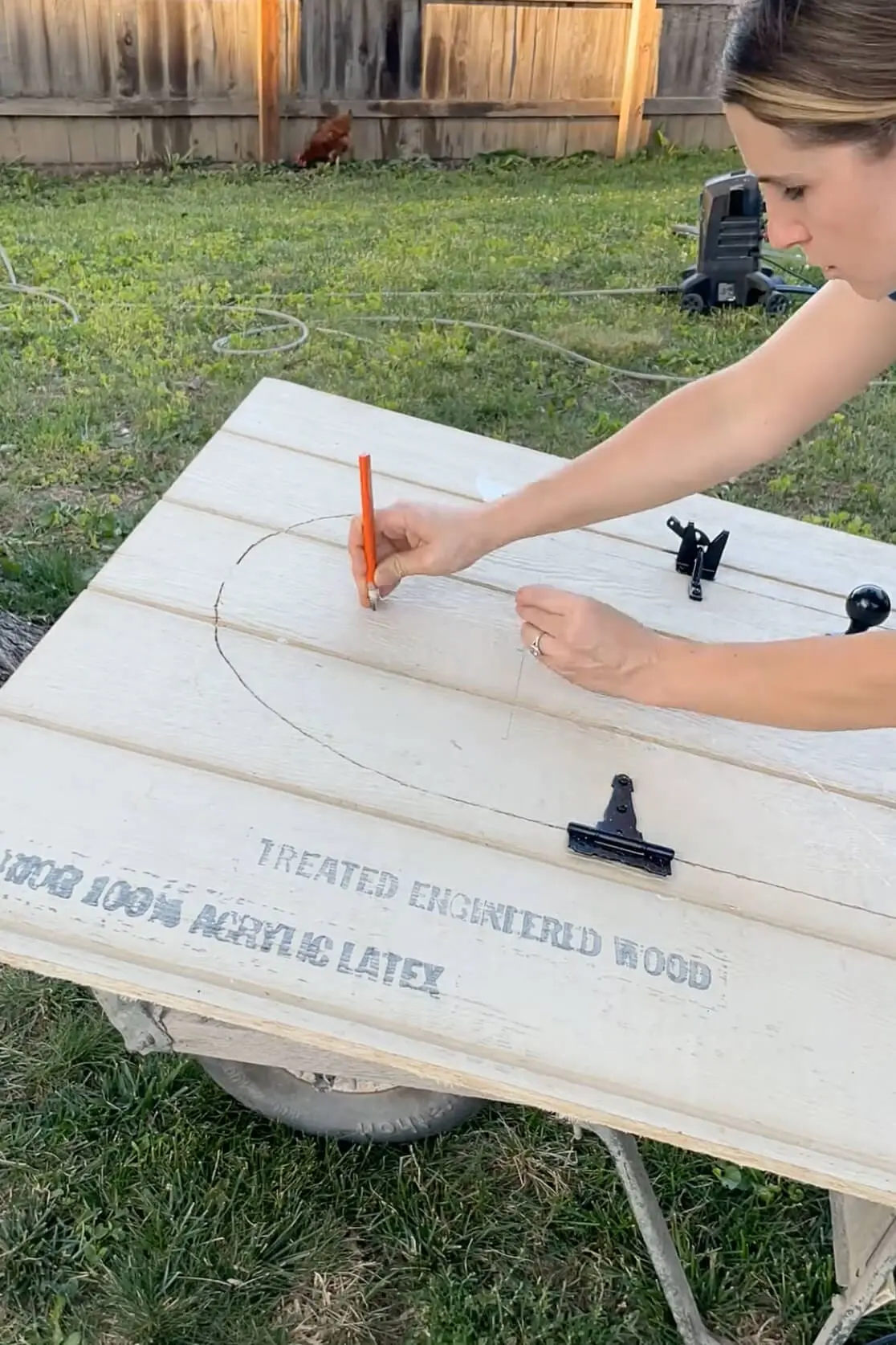 Drawing a window on the door of our backyard chicken coop.